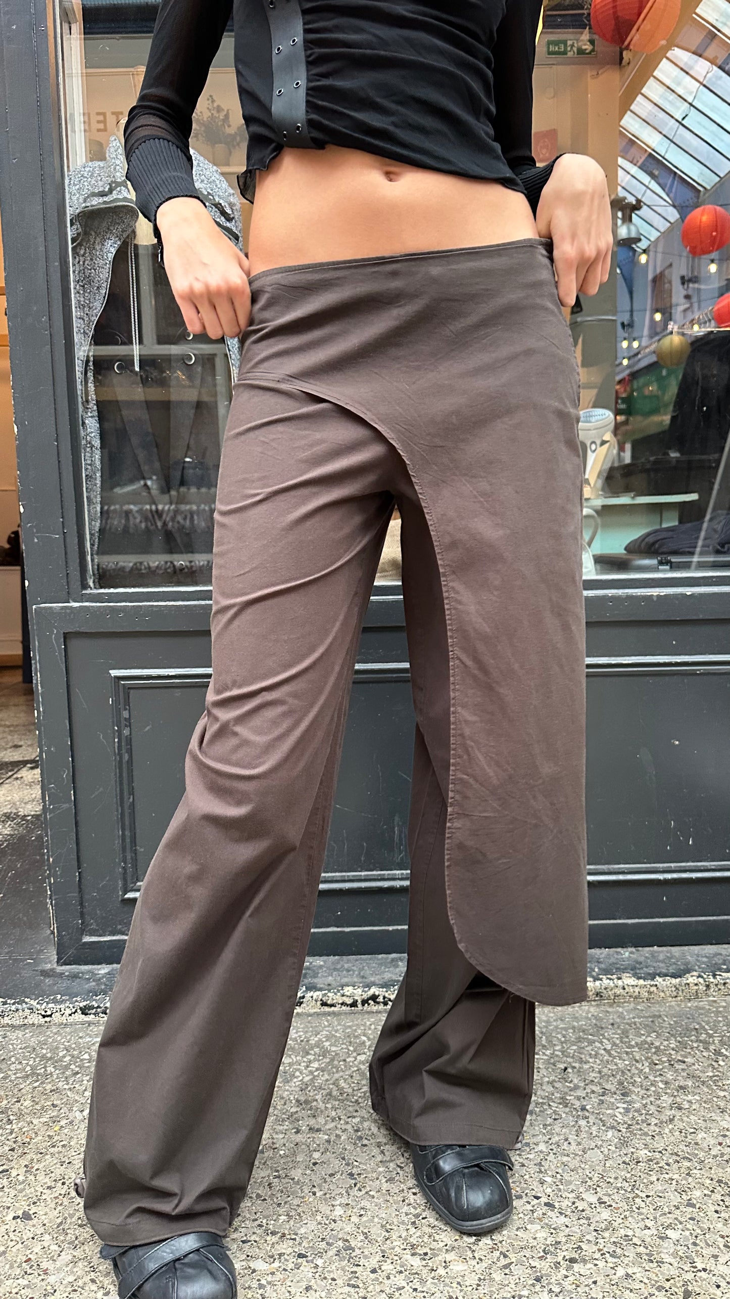 Brown trousers with asymmetric leg