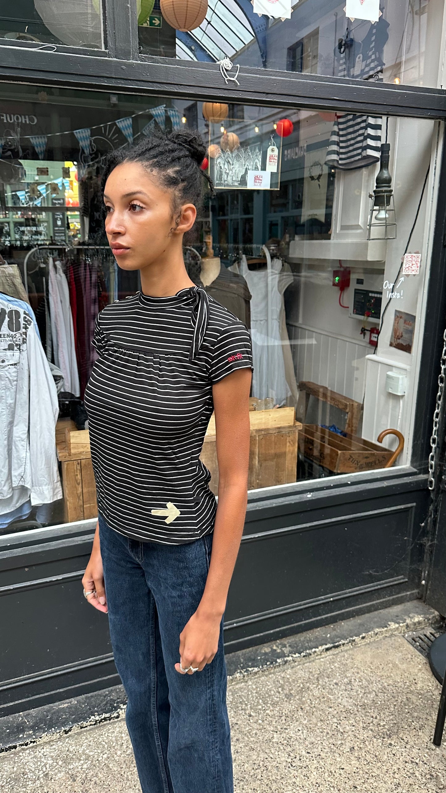 black and white striped top with high neck