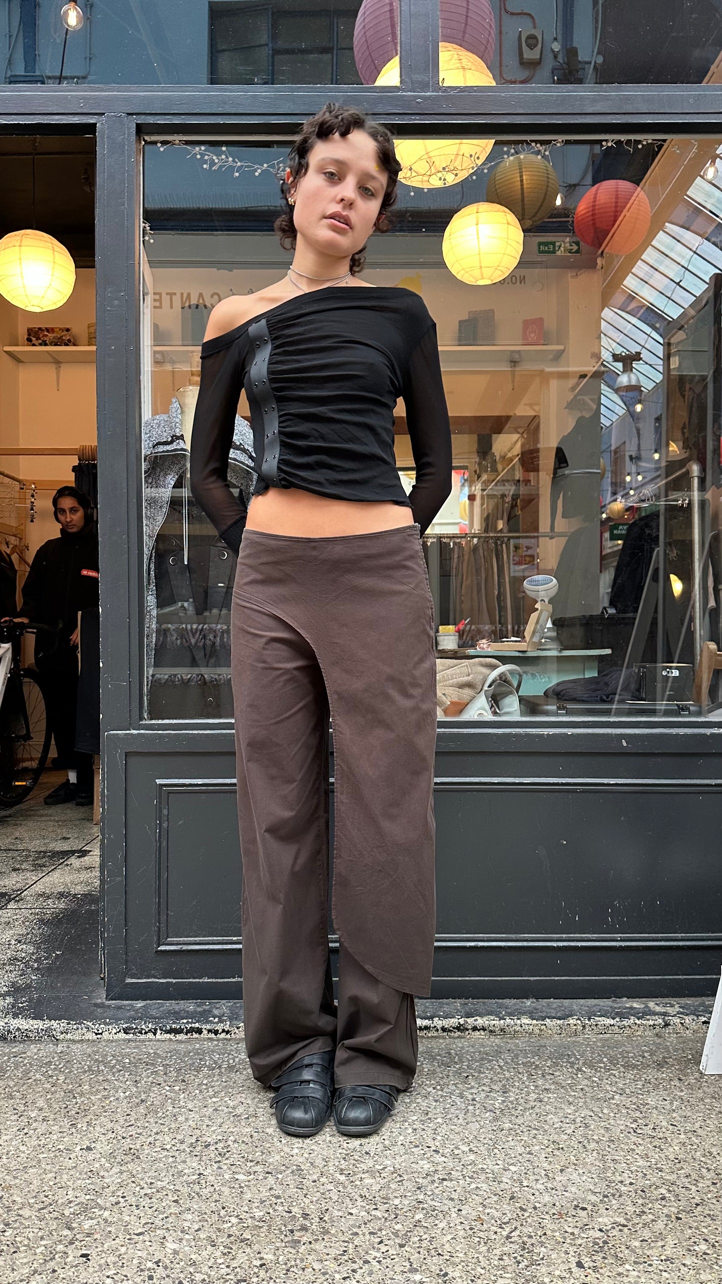 Brown trousers with asymmetric leg