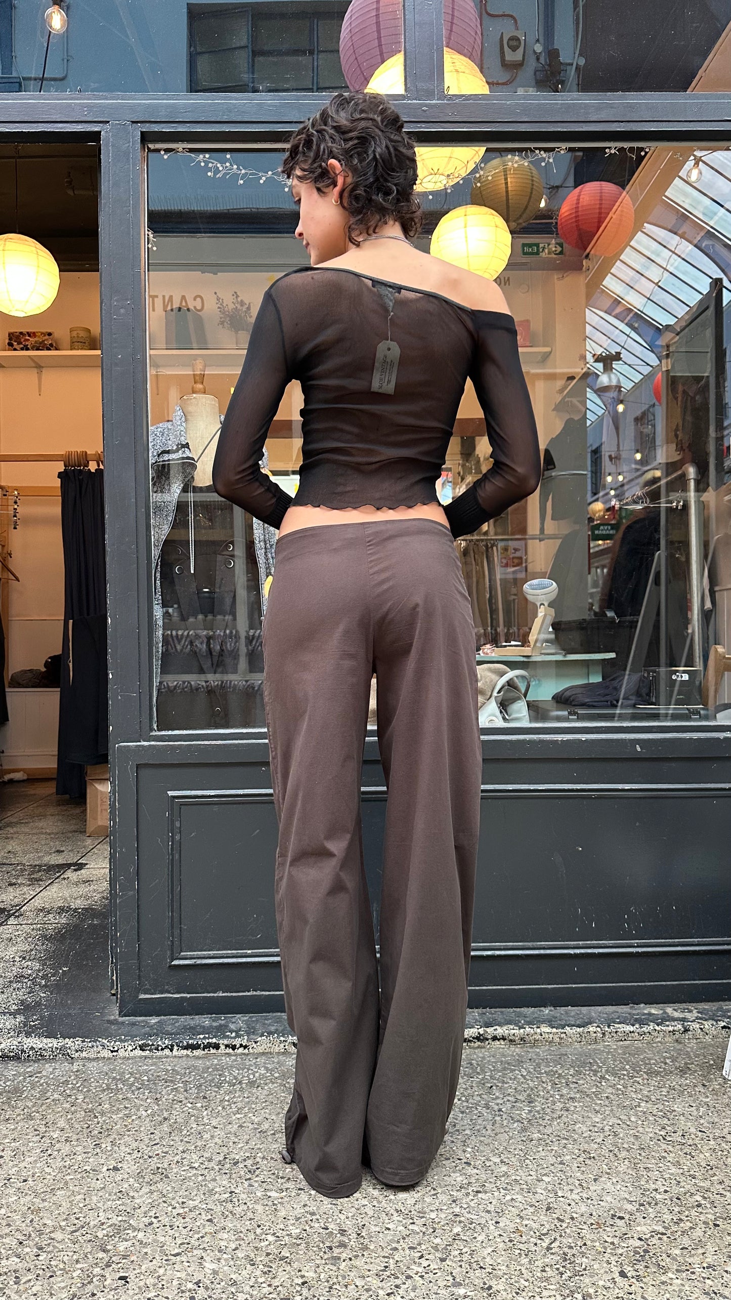 Brown trousers with asymmetric leg